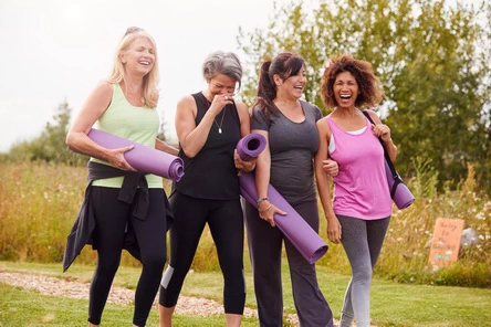 4 women talking a walk to Yoga class