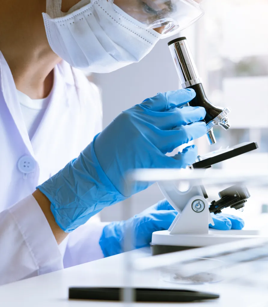 Picture of a lady tech using a microscope